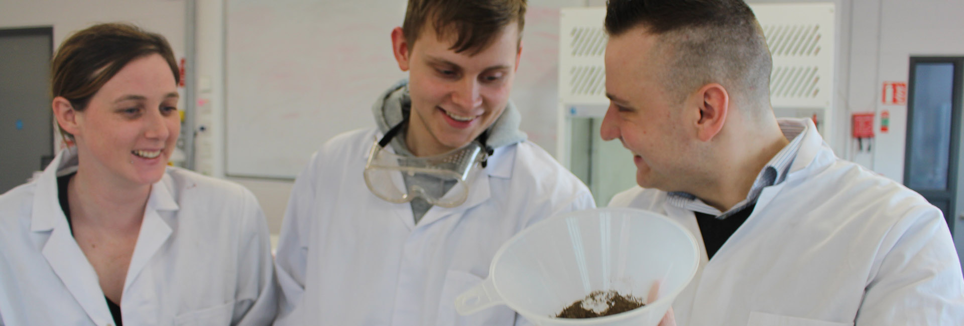 3 MI Students in the Lab carrying out an experiment