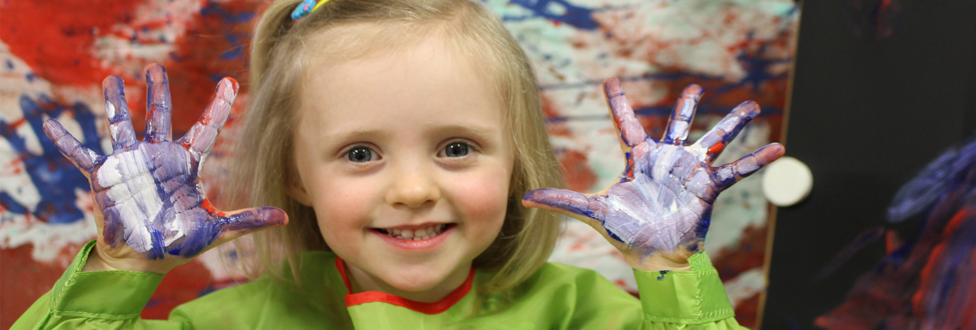 Child Care Early Learning Years - Girl Smiling with paint on her hands