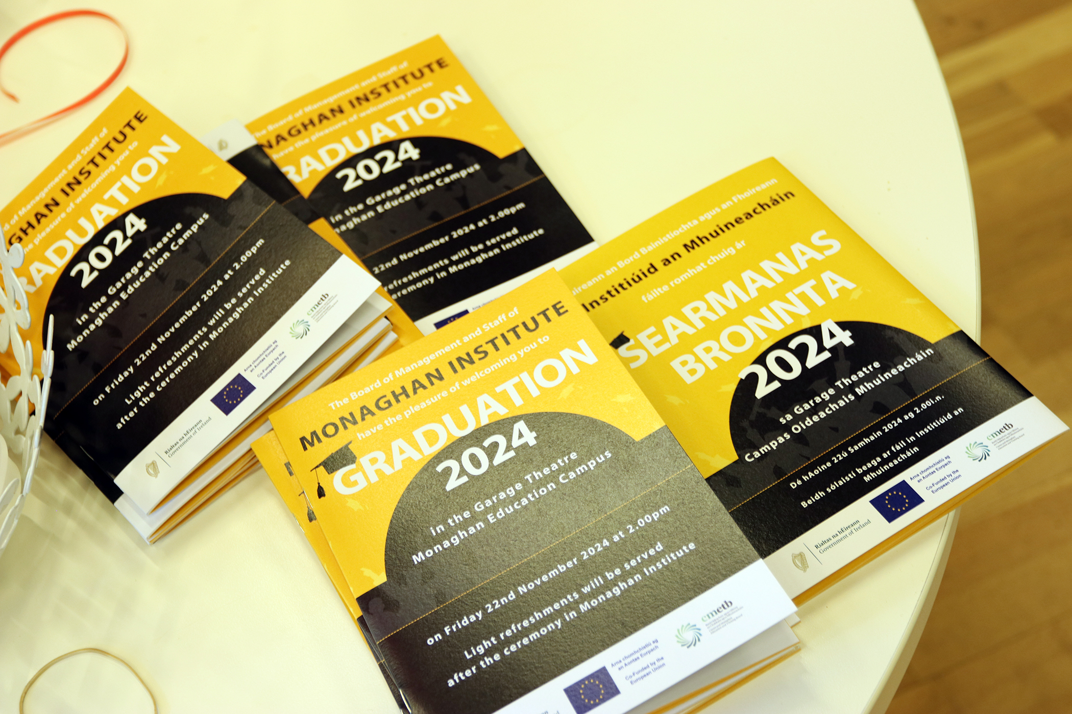 Four stacks of Monaghan Institute graduation invites