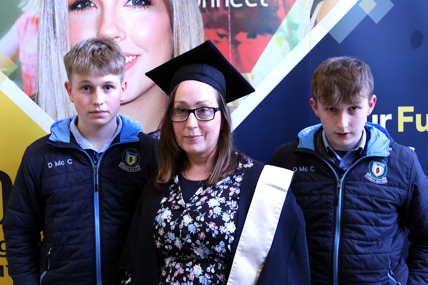 Woman graduating with cap and gown with family