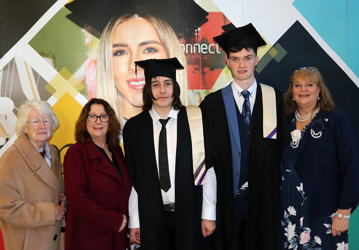 Students with cap and gown with family