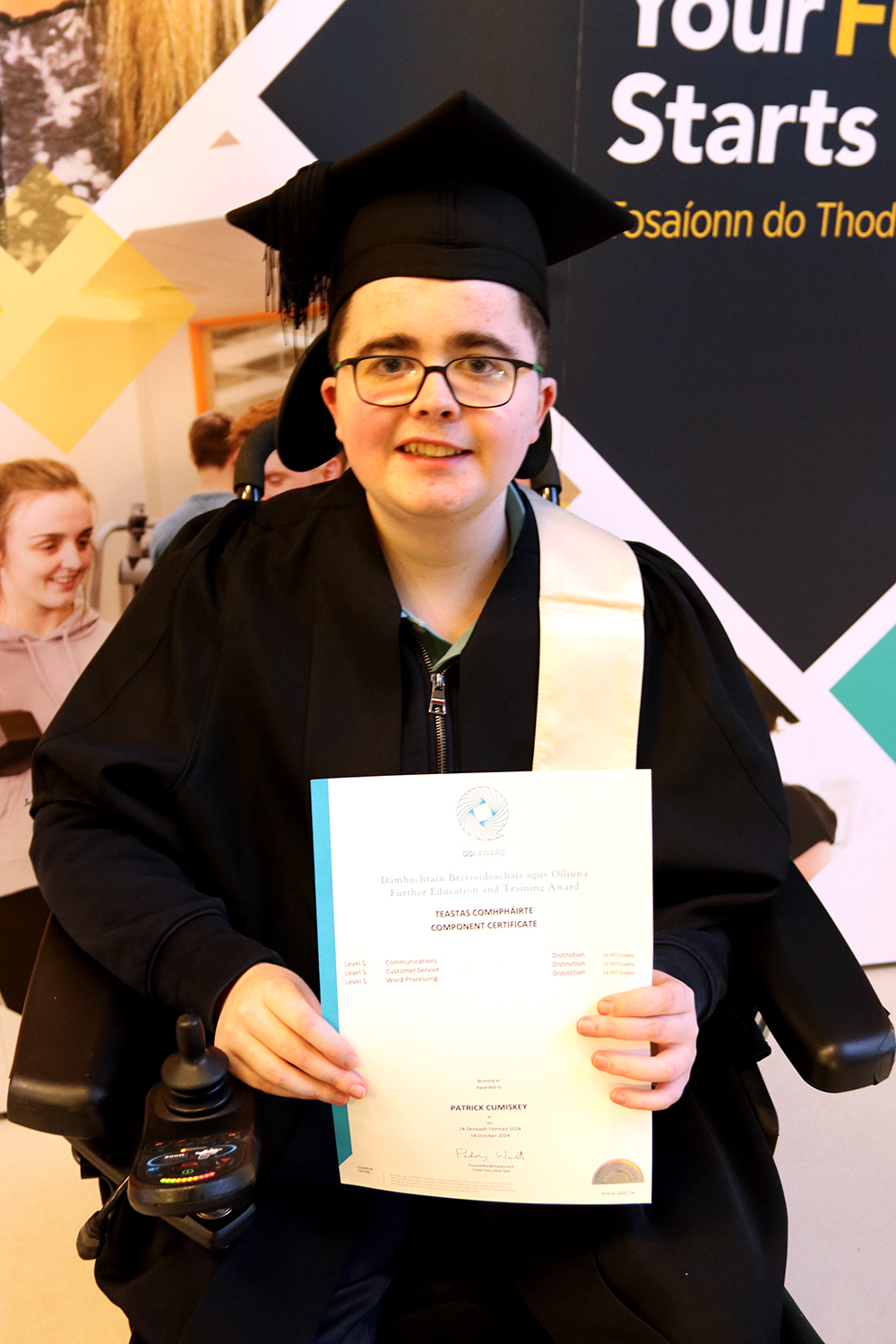 Student with cap and gown holding certificate