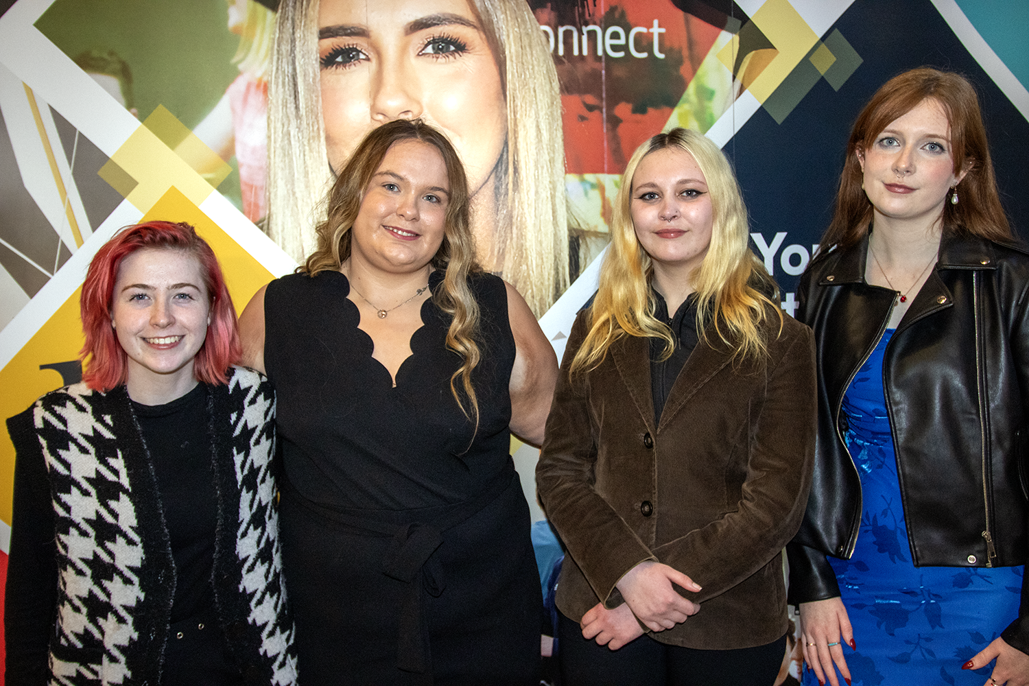 Four girls standing smiling